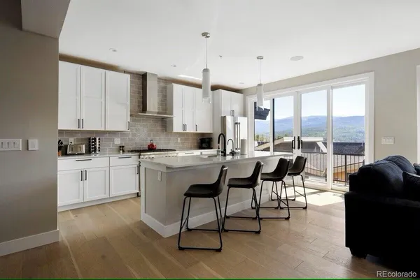 a kitchen with counter top space a sink appliances and cabinets