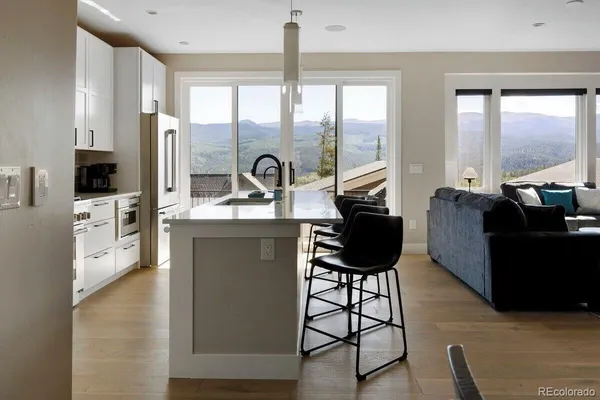 a living room with furniture a flat screen tv and a floor to ceiling window