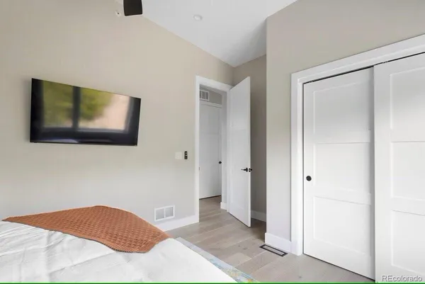 a bedroom with a bed and a flat screen tv