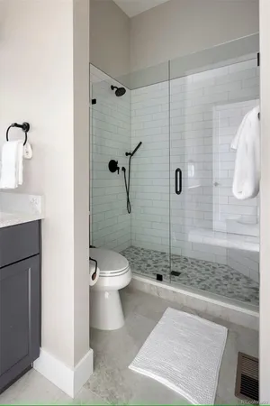 a bathroom with a toilet and a shower