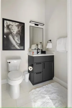 a bathroom with a toilet a sink and mirror