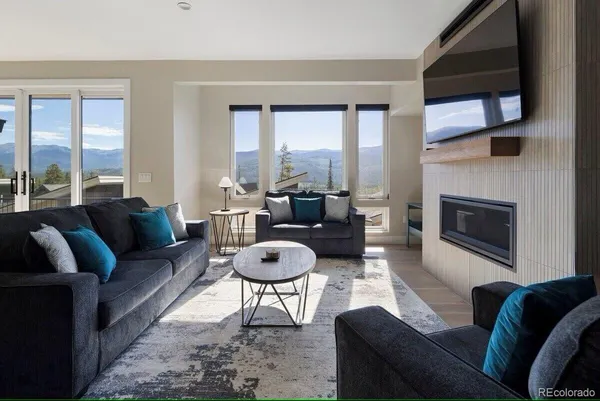 a living room with furniture and a fireplace