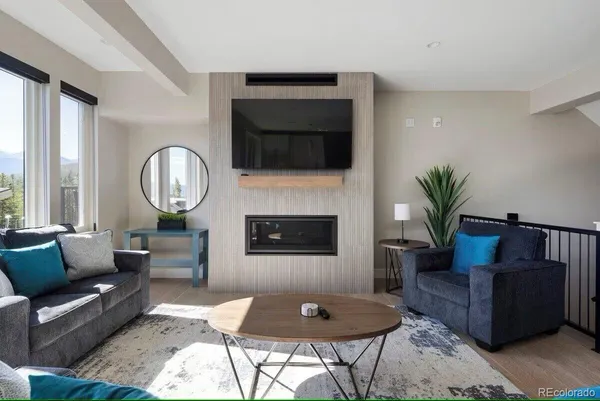 a living room with furniture and a fireplace