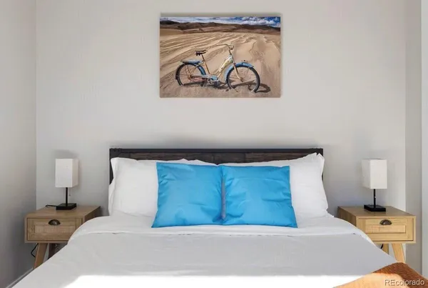 a bedroom with a bed and wall painting