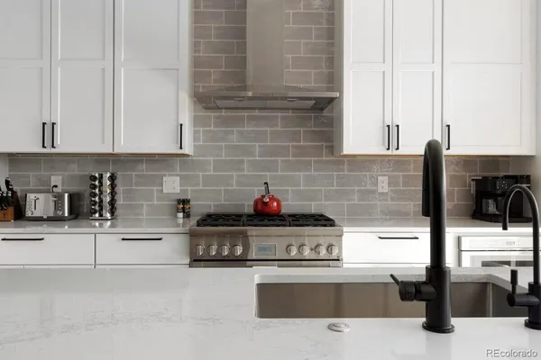 a kitchen with stainless steel appliances kitchen island granite countertop a sink and a stove