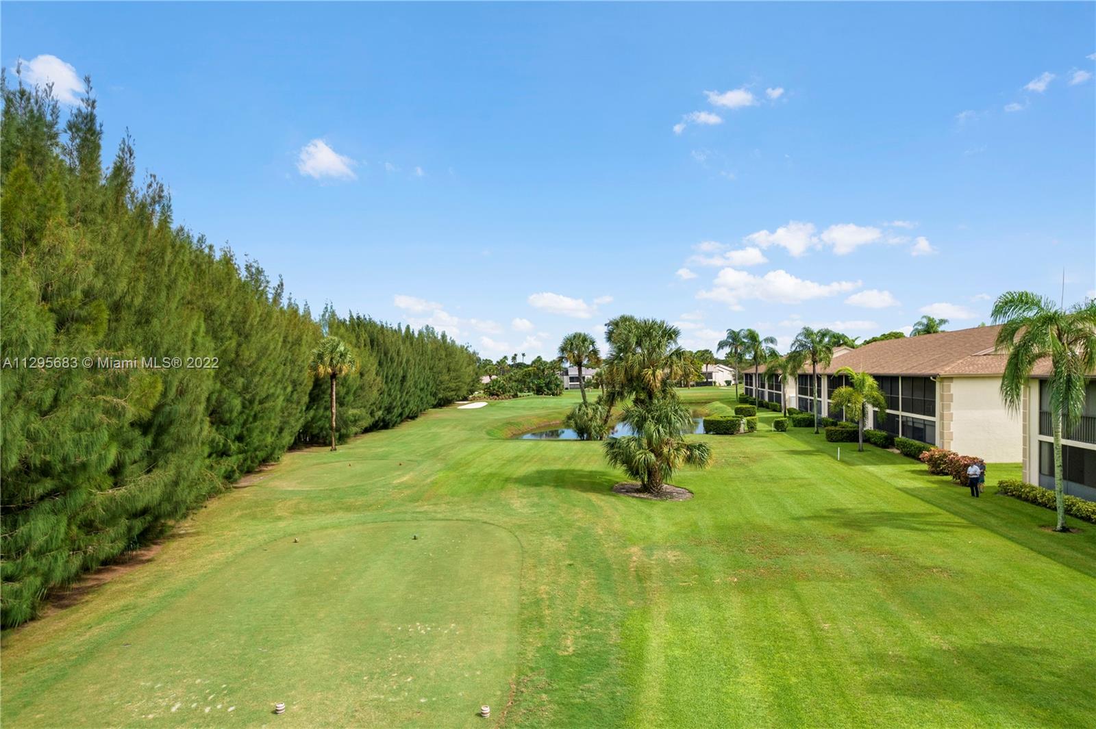 101 Pinecrest Circle, Unit E Jupiter, FL 33458 - Photo 17 of 20 a swimming pool with outdoor seating and yard