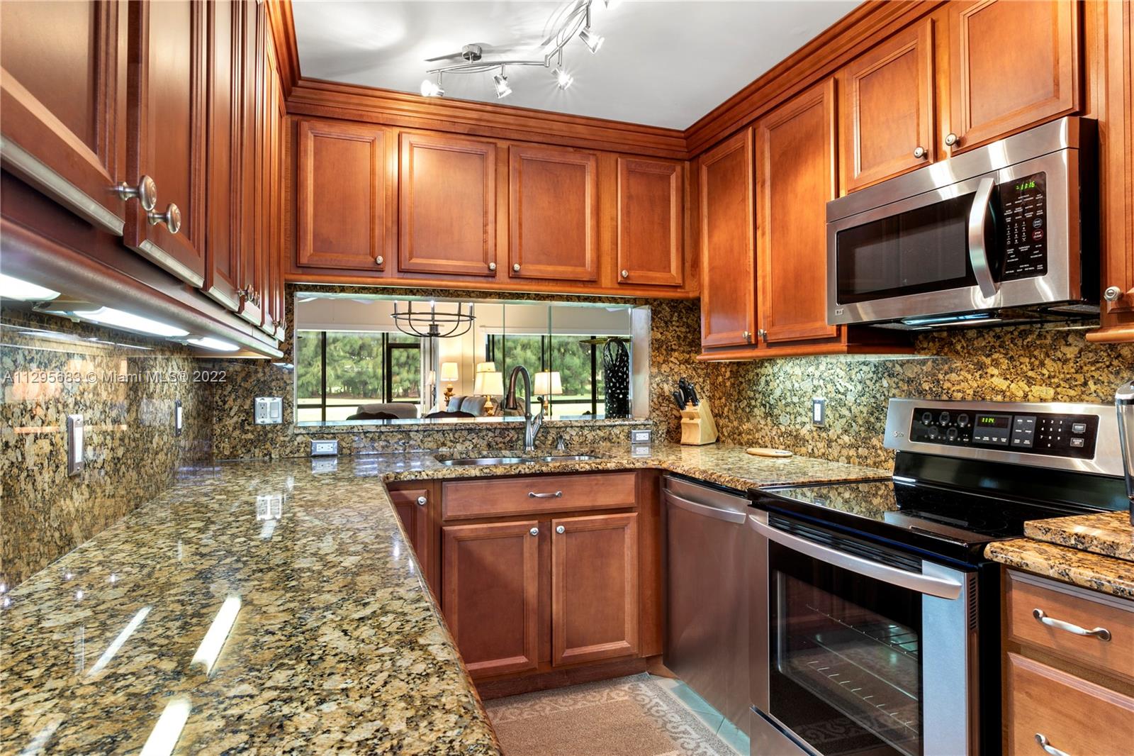 101 Pinecrest Circle, Unit E Jupiter, FL 33458 - Photo 3 of 20 a kitchen with a sink stove and microwave