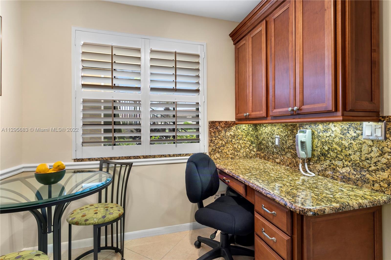 101 Pinecrest Circle, Unit E Jupiter, FL 33458 - Photo 4 of 20 a kitchen with granite countertop sink and chairs