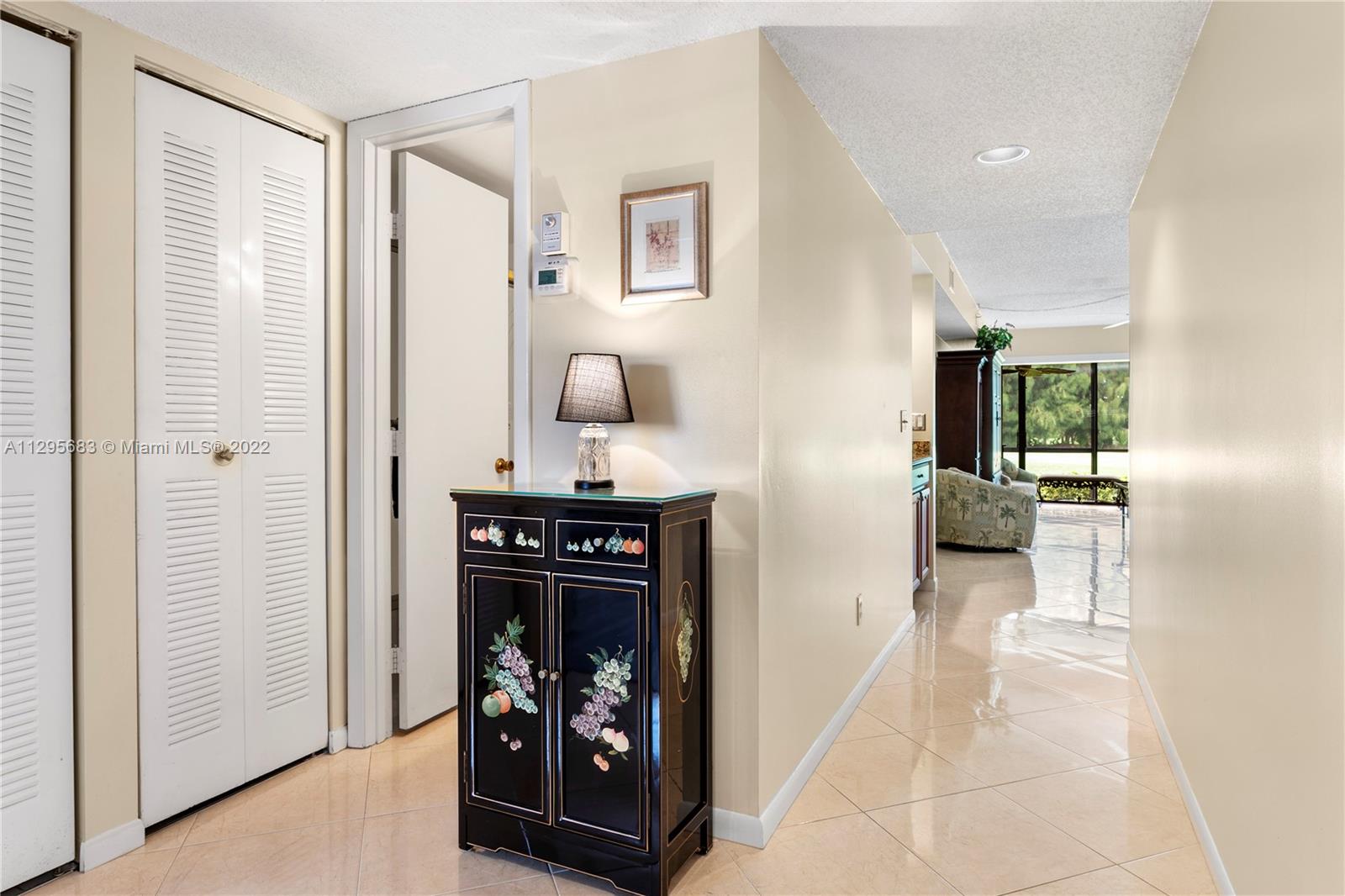 101 Pinecrest Circle, Unit E Jupiter, FL 33458 - Photo 6 of 20 a view of a livingroom with wooden floor and a fireplace