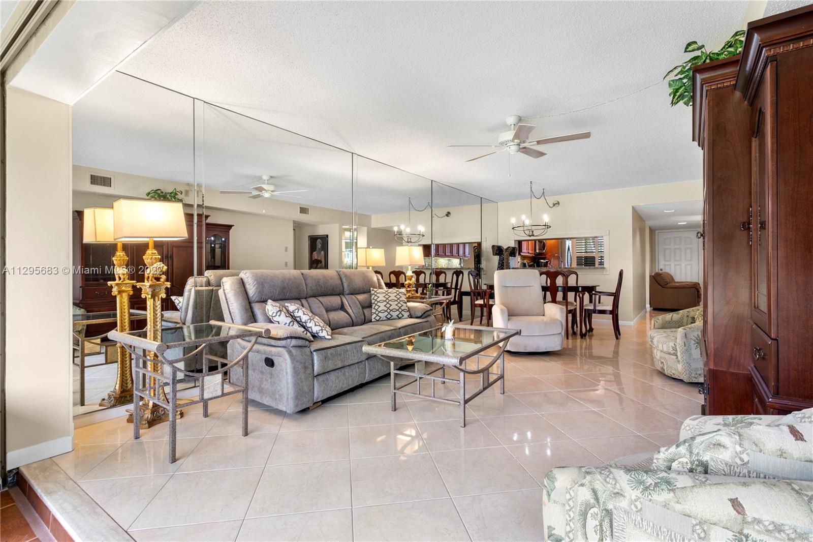 101 Pinecrest Circle, Unit E Jupiter, FL 33458 - Photo 7 of 20 a living room with lots of furniture and a view of kitchen