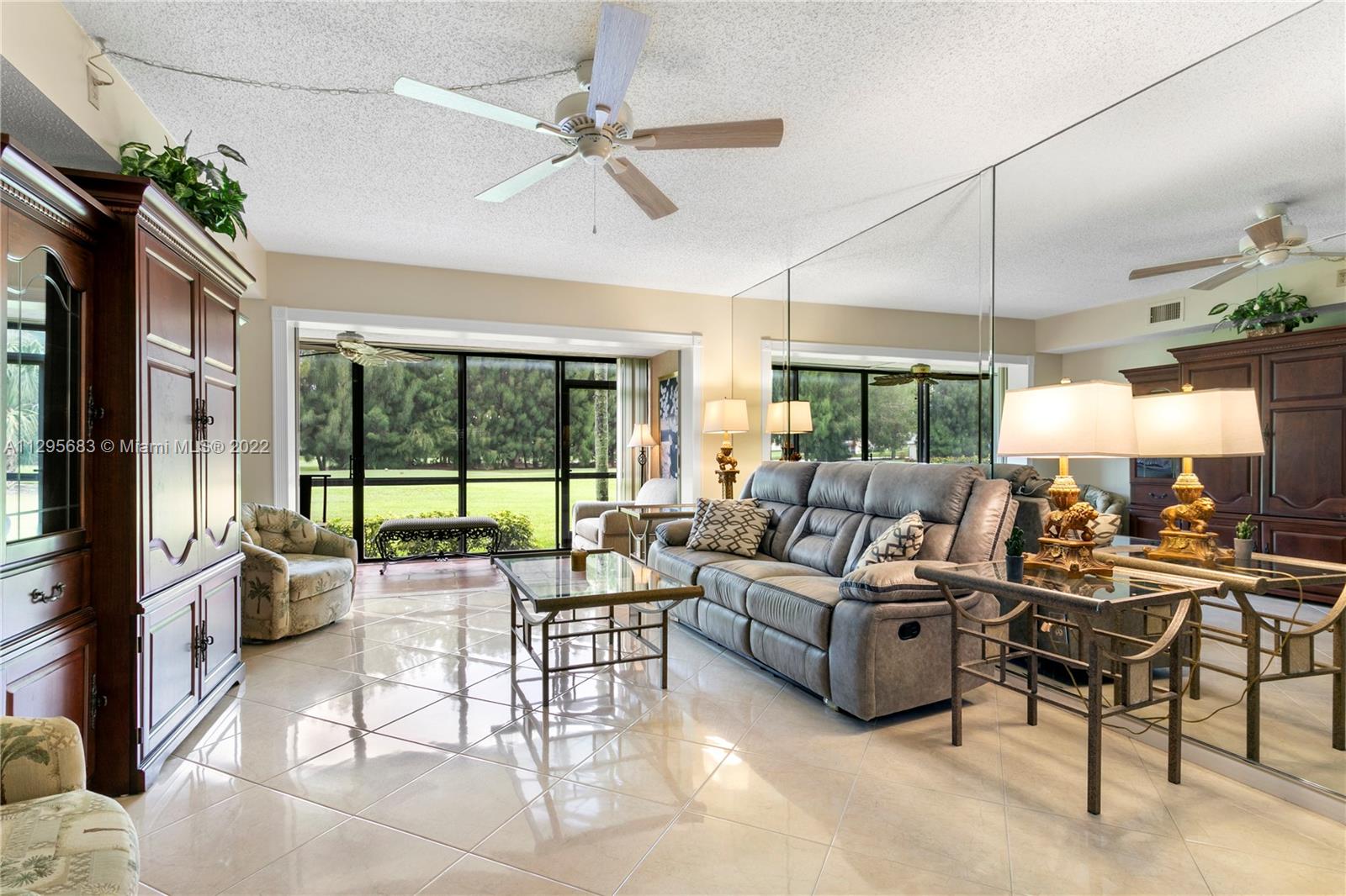 101 Pinecrest Circle, Unit E Jupiter, FL 33458 - Photo 8 of 20 a living room with lots of furniture and a large window
