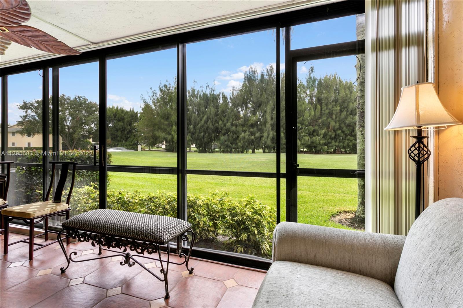 101 Pinecrest Circle, Unit E Jupiter, FL 33458 - Photo 10 of 20 a living room with furniture and a floor to ceiling window