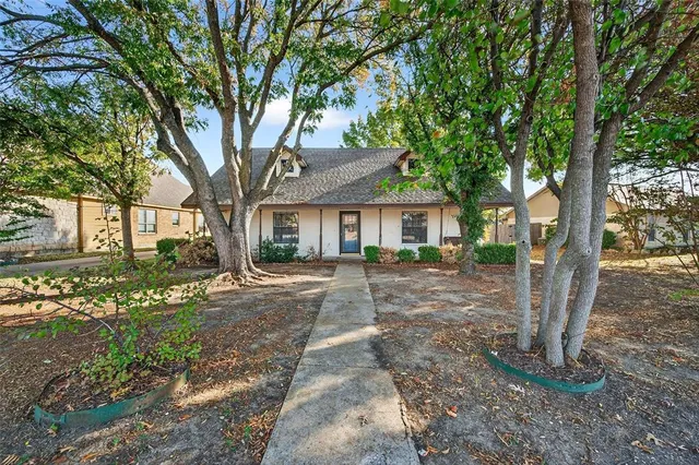 a view of a house with a tree in front