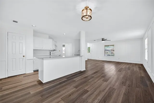 a kitchen with a sink a stove and cabinets