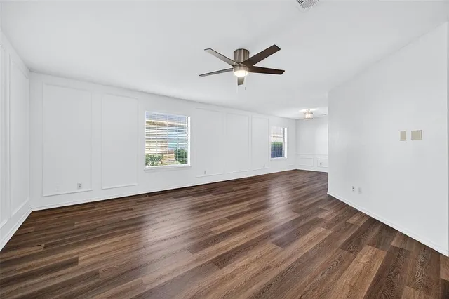 a kitchen with stainless steel appliances white cabinets a sink dishwasher a stove and a microwave oven with granite countertops