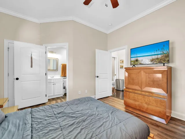 a bedroom with a bed and a refrigerator