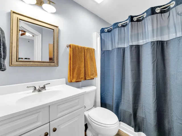 a bathroom with a toilet a sink and a mirror