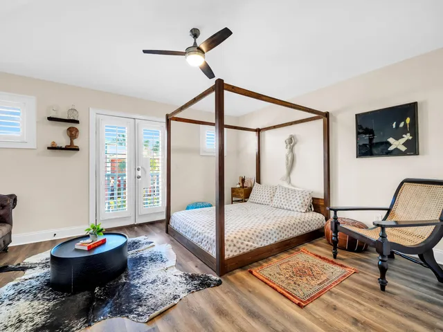 a bedroom with a bed and a chandelier