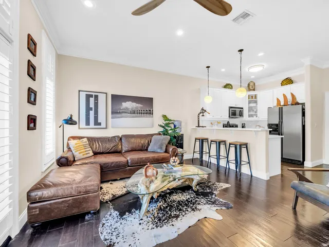 a living room with furniture a rug and a chandelier