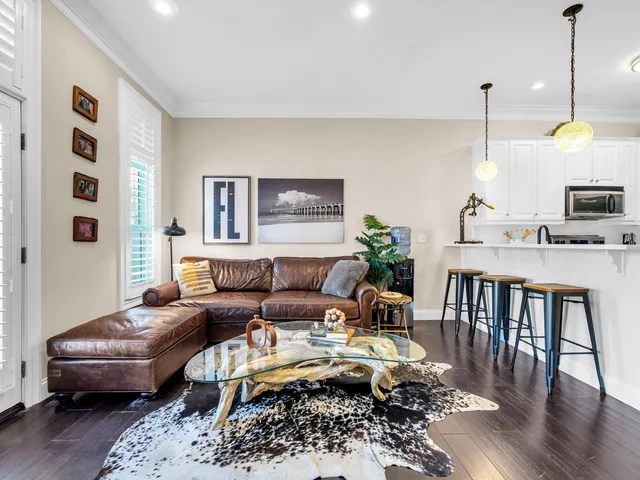 a living room with furniture wooden floor and a chandelier