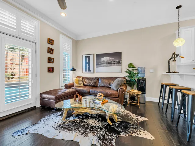 a living room with furniture wooden floor and a window