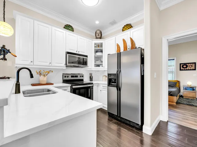 a kitchen with a refrigerator and a stove top oven