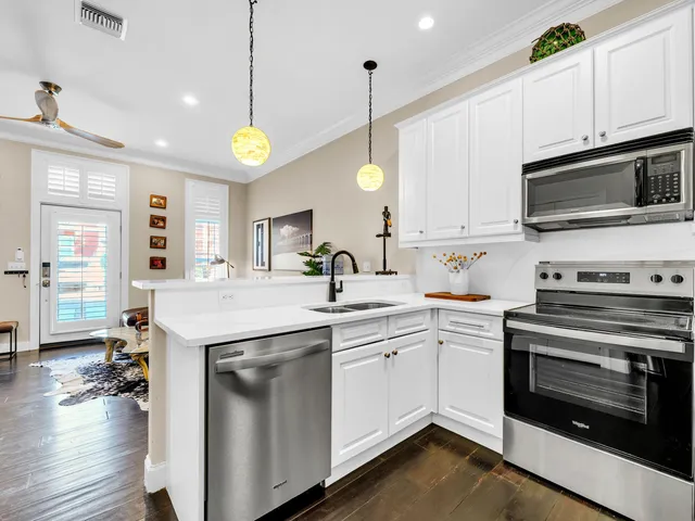 a kitchen with a sink cabinets and wooden floor