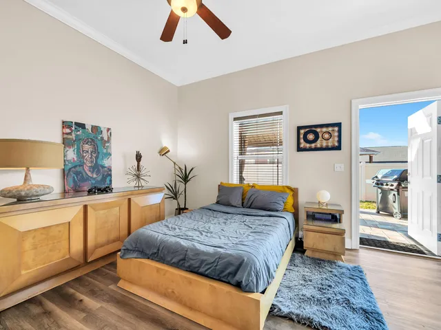 a bedroom with a large bed and a chandelier