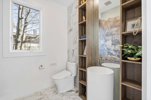 a bathroom with a toilet a sink and a mirror