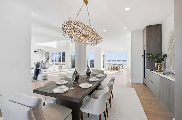 a view of a dining room with furniture wooden floor and chandelier
