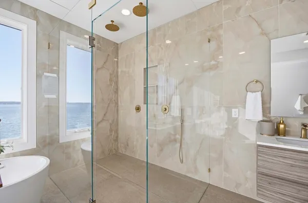 a bathroom with a shower sink and mirror