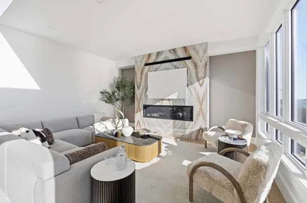 a living room with furniture and a mirror