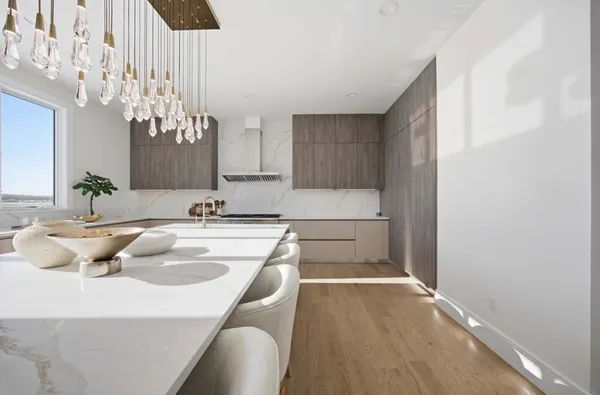 a kitchen with a sink cabinets and chandelier