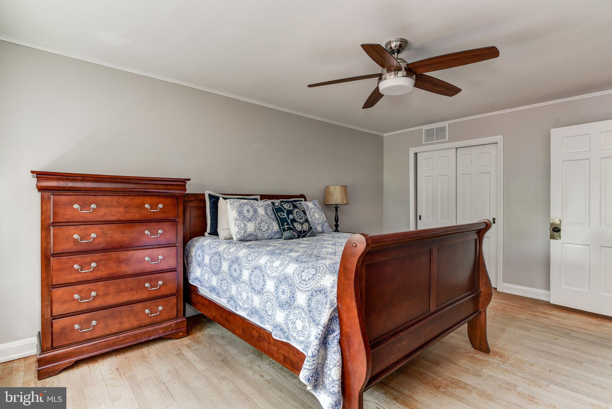 506 Academy Road Baltimore, MD 21228 - Photo 23 of 49 a bedroom with a bed and a ceiling fan