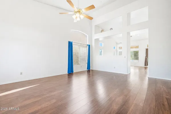 a view of a room with a ceiling fan and a window