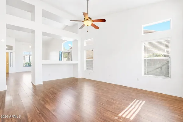 a view of a livingroom with a ceiling fan and window