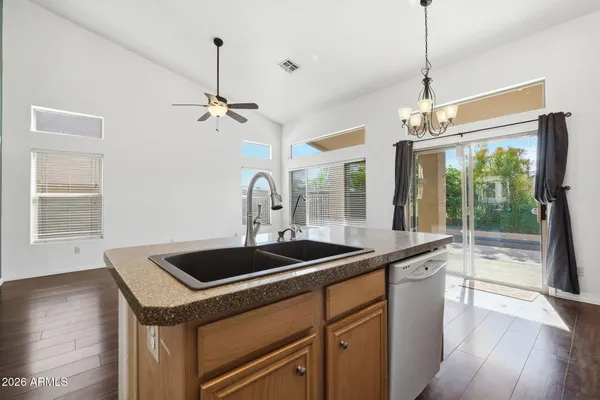 a spacious bathroom with a granite countertop sink a mirror and a bathtub