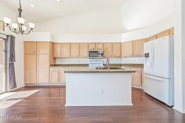 a view of a livingroom with wooden floor and a ceiling fan