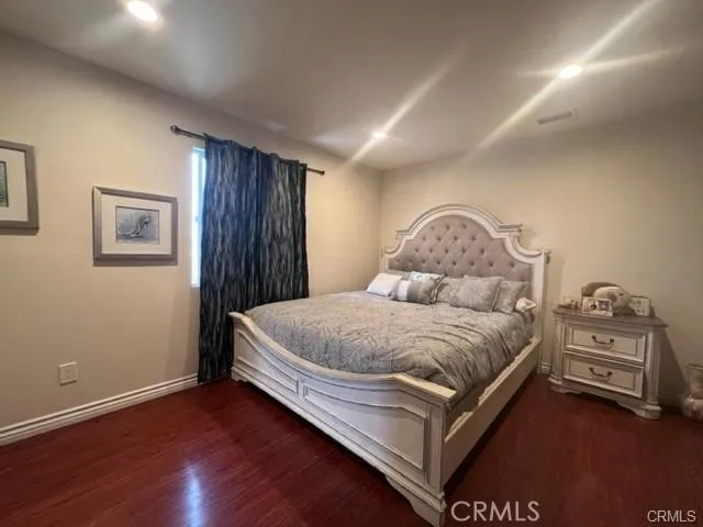 a bedroom with a bed and a night stand