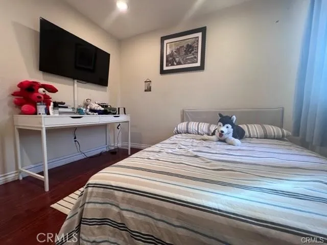 a bedroom with a bed and a flat screen tv