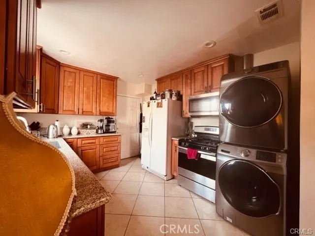 a kitchen with a refrigerator sink and cabinets