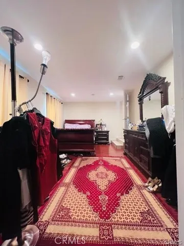 a living room with furniture a rug and a flat screen tv