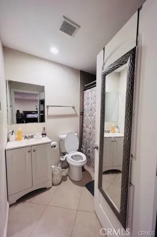 a bathroom with a sink mirror vanity and toilet