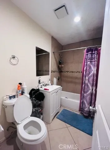 a bathroom with a sink toilet mirror vanity and shower
