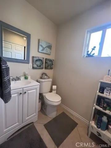 a white toilet sitting next to a bathroom sink