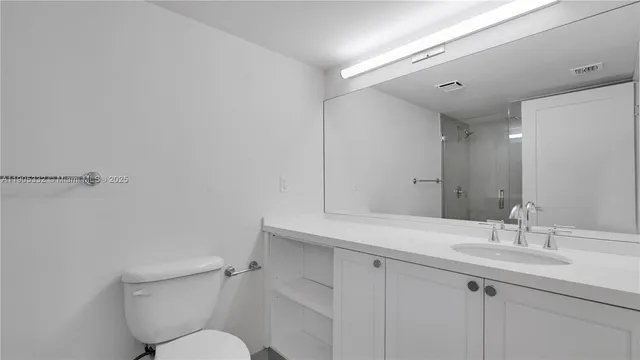 a bathroom with a shower and a toilet