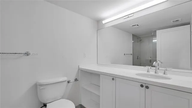 a bathroom with a shower and a toilet