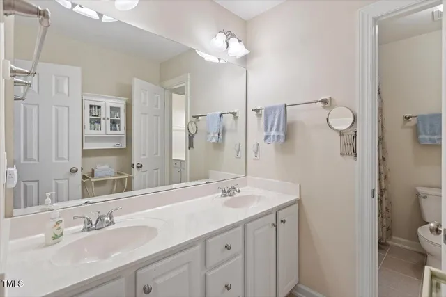 a bedroom with furniture and a mirror