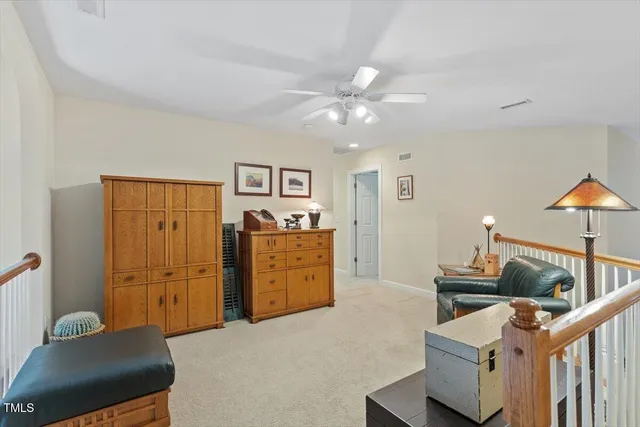 a view of a backyard with fountain plants and large trees