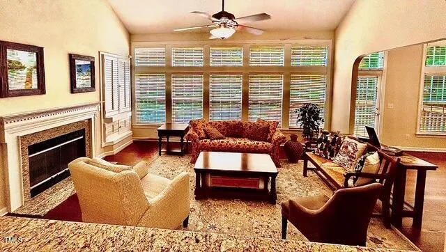 a living room with furniture a flat screen tv and a fireplace